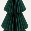 Close-up of dark green folded paper and tier edges on a standing Christmas tree.