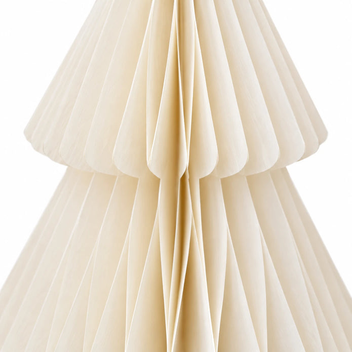 Close-up of winter white folded paper and tier edges on a standing Christmas tree.