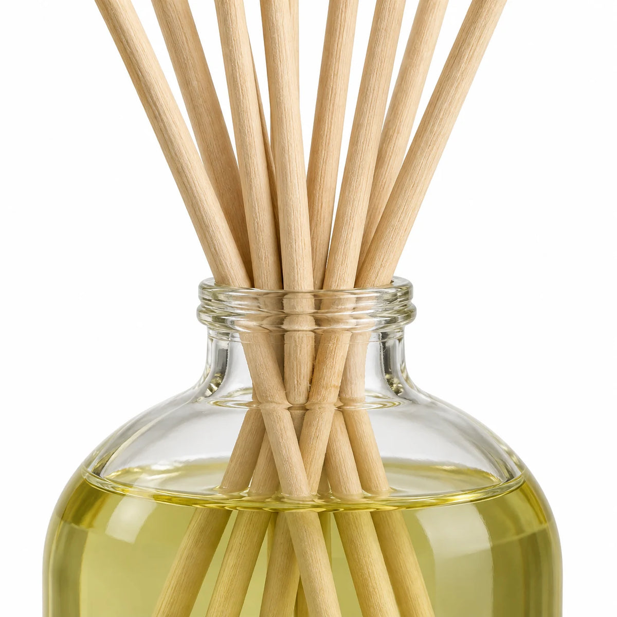 Heaven Scent MOROCCAN ROSE 100ml reed diffuser close-up of natural rattan reeds and the glass bottle neck.