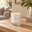 Heaven Scent Moroccan Rose Small Candle, ivory wax in clear glass on an oak console