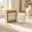 Heaven Scent Moroccan Rose Small Candle, unlit with its brown kraft box on a cream console