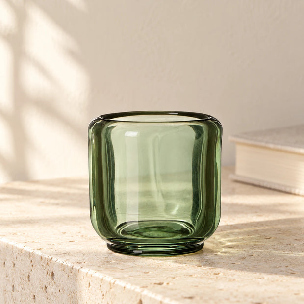 Moss Green Tealight Candle Holder — smooth holder empty on pale stone ledge