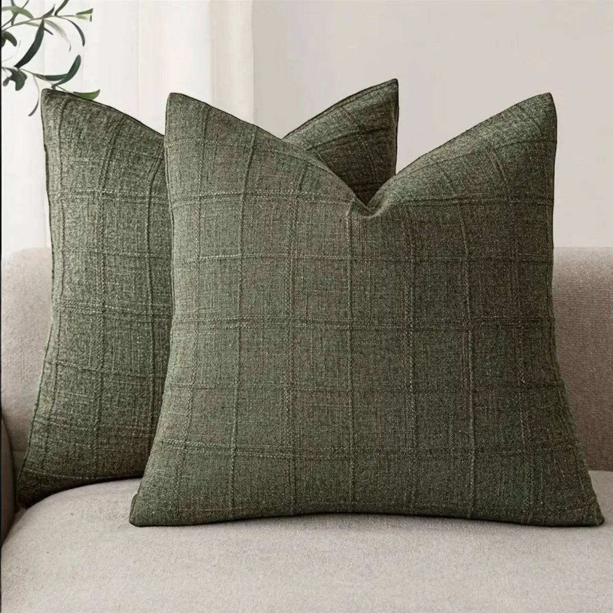 Olive green woven square cushion cover with intricate design, soft furnishings by Starlight Express, fabric texture visible.