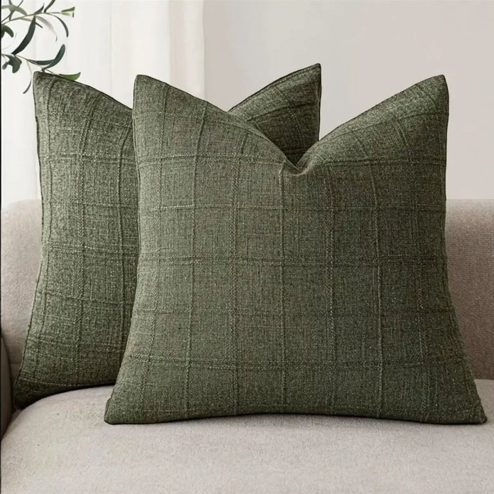 Olive green woven square cushion cover with intricate design, soft furnishings by Starlight Express, fabric texture visible.