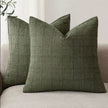 Olive green woven square cushion cover with intricate design, soft furnishings by Starlight Express, fabric texture visible.