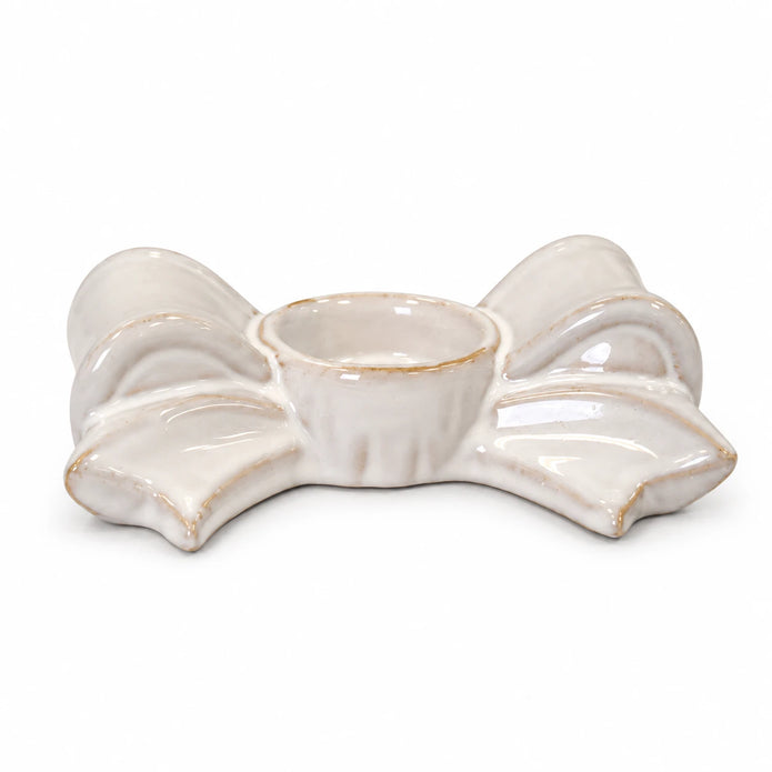 Complete natural ceramic bow tealight holder, empty, on a white background