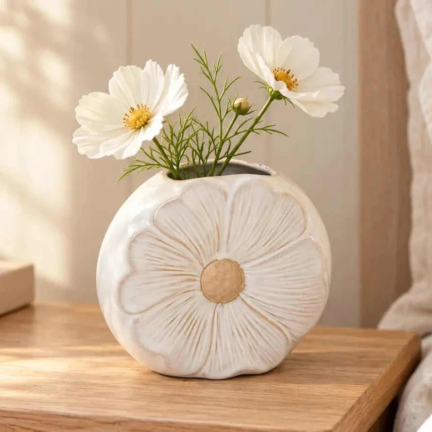 Natural ceramic vase with a delicate flower design, perfect for displaying fresh or dried flowers.