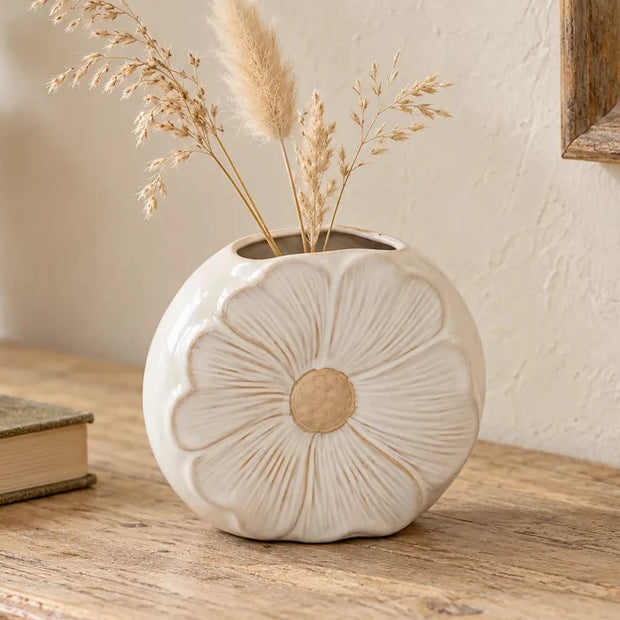 Large white ceramic vase with detailed flower petal design, perfect for displaying dried stems or floral arrangements.