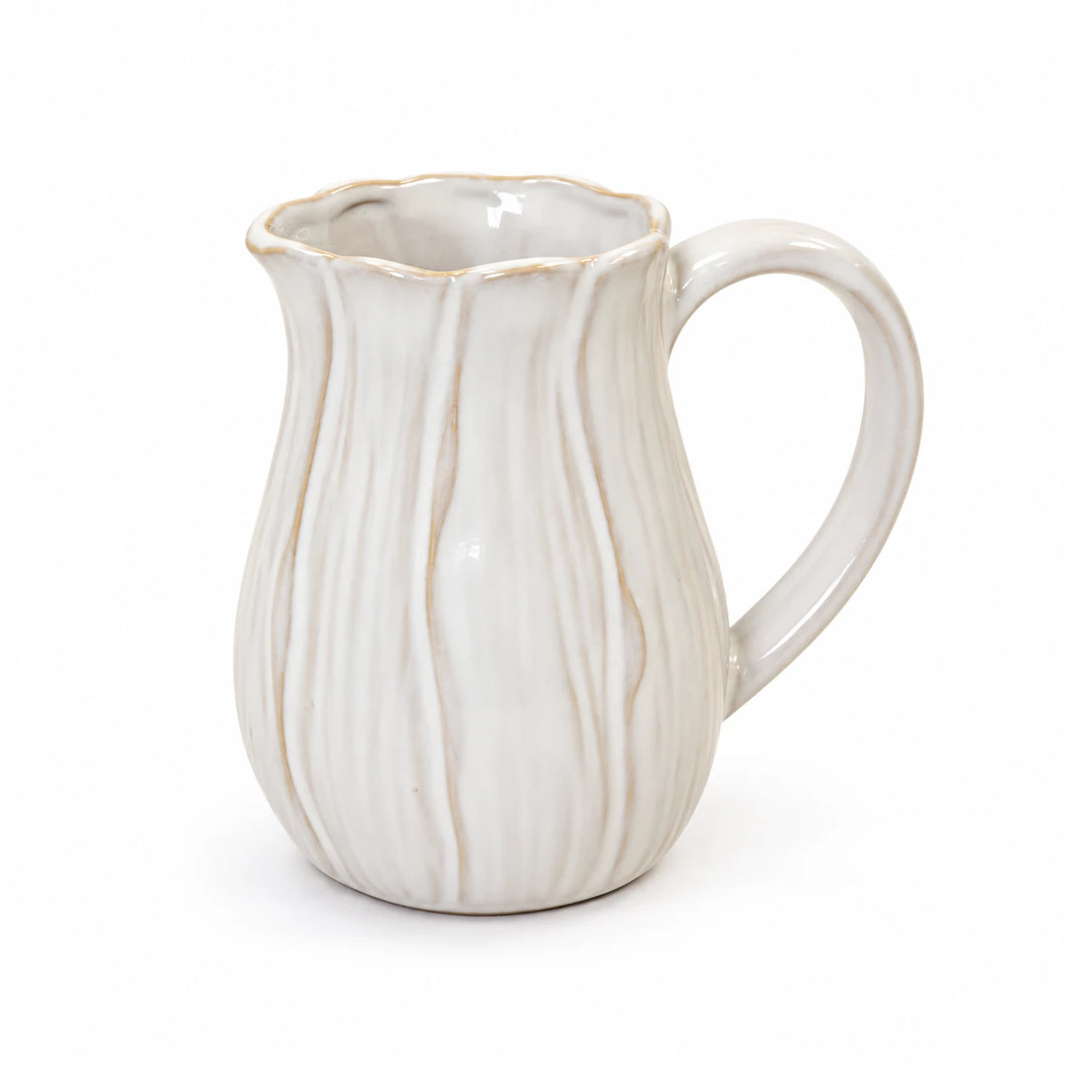 Small natural ceramic jug with wavy petal contours and scalloped rim on a white background