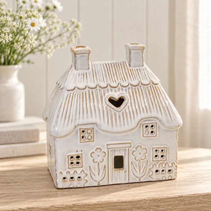 Natural ivory ceramic thatch roof tealight house, 16cm wide, hero view, shown empty.
