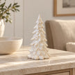 Small natural layered ceramic tree displayed on a stone sideboard.