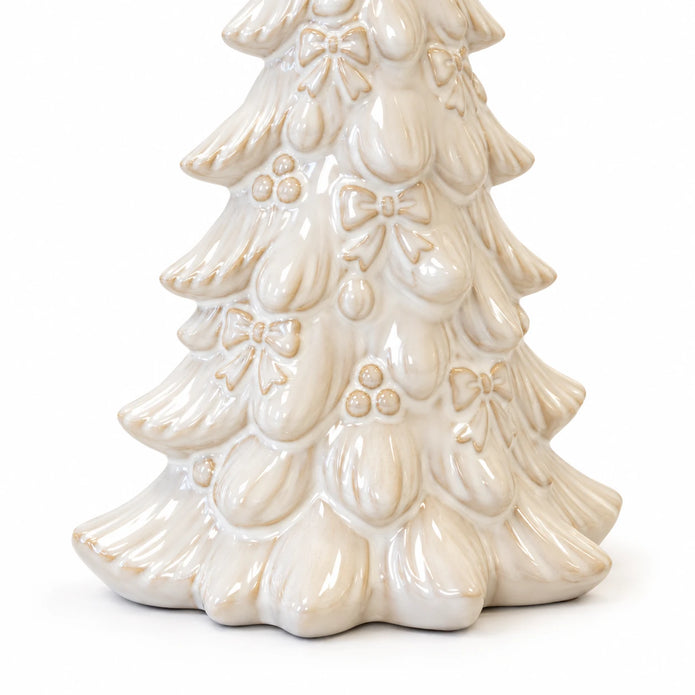 Close-up of raised bows, baubles and layered branches on the ivory ceramic Christmas tree against white.