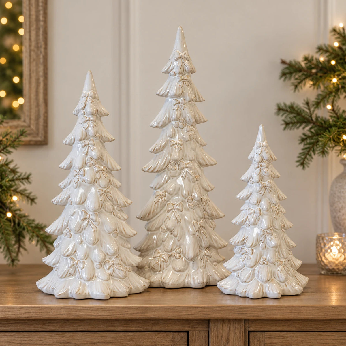 Natural ivory layered Christmas trees shown together for size comparison: medium 37cm, large 44cm and small 26cm; sold separately.
