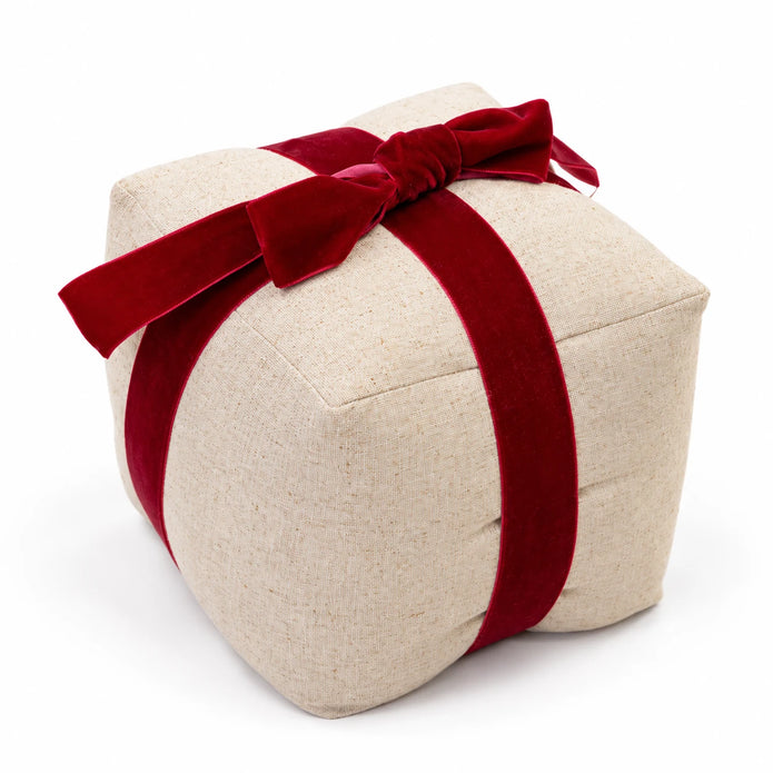 Studio view of natural linen present doorstop with crossed red velvet ribbon and bow