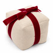 Elevated studio view of Christmas present doorstop showing linen texture and red velvet bow