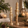 Medium and large natural wooden nutcracker decorations in a neutral Christmas home setting, photograph 1