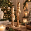 Medium and large natural wooden nutcracker decorations in a neutral Christmas home setting, photograph 3