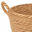 Close-up of the natural woven basket handle, braided rim and zigzag stitching on white