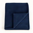 Navy Blue Luxury Snuggle Blanket Throw, folded navy blue throw with its corner turned back on white