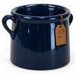 Elevated detail of the navy pot showing its rolled rim, handles and glossy glaze