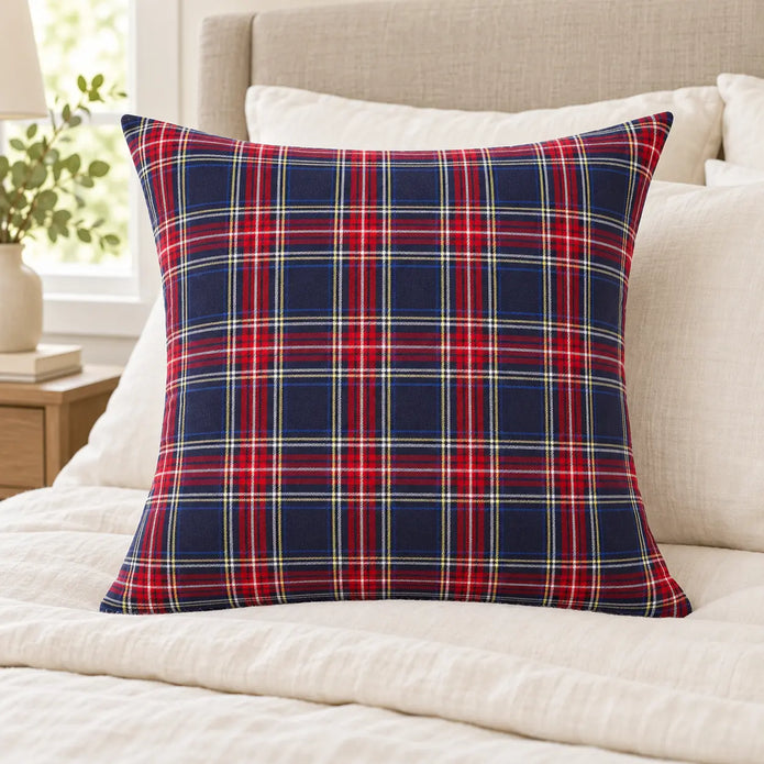 Navy and red check cushion cover styled on ivory bedding, inner not included