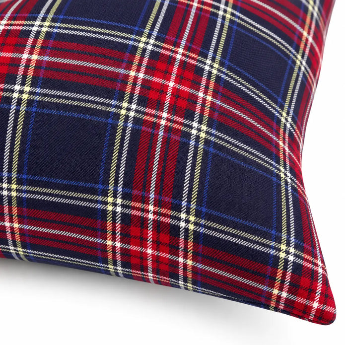 Close-up of navy red and ivory tartan fabric and sewn cushion cover edge