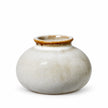 Small neutral ceramic mini bud vase with a rounded cream speckled body and brown glazed rim, shown empty on white.