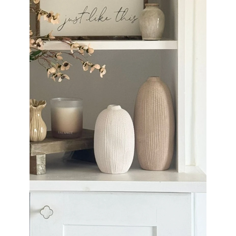 Tall beige textured stone vase by Satchville with a neutral ribbed surface, perfect for displaying flowers or decorative arrangements.
