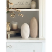 Tall beige textured stone vase by Satchville with a neutral ribbed surface, perfect for displaying flowers or decorative arrangements.