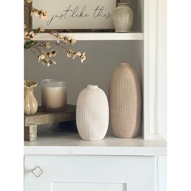 Tall beige textured stone vase by Satchville with a neutral ribbed surface, perfect for displaying flowers or decorative arrangements.