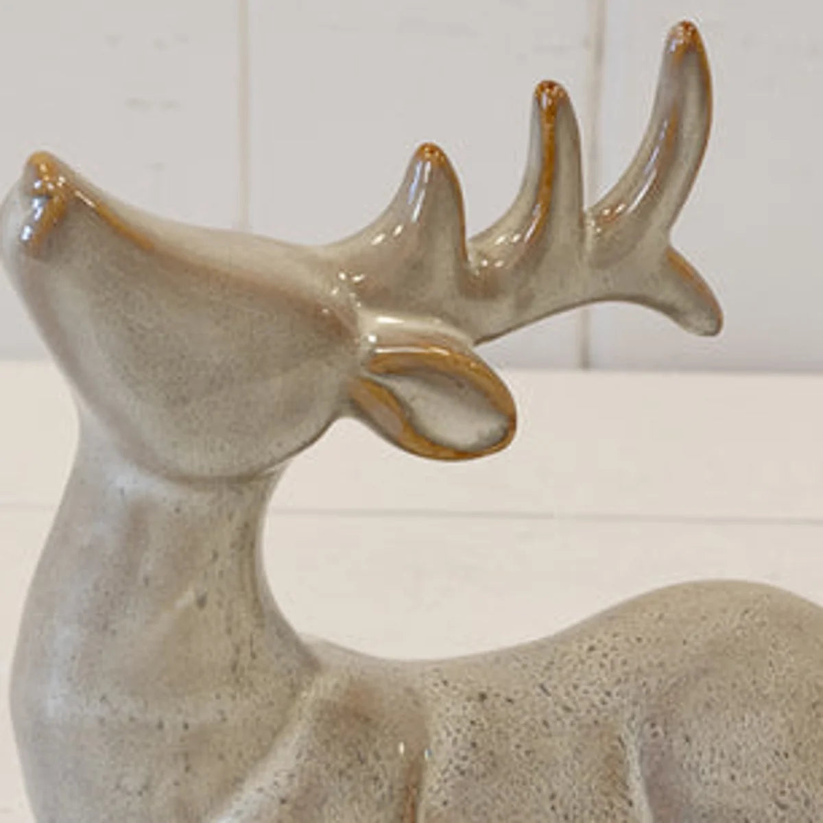 Close-up of neutral reindeer ceramic glaze and sculpted antlers with brown accents