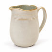 Studio view of neutral stoneware jug showing grey-green interior and warm-toned rim
