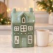 Satchville Nordic Green Ceramic Tealight Holder House - Large, styled in a kitchen countertop setting