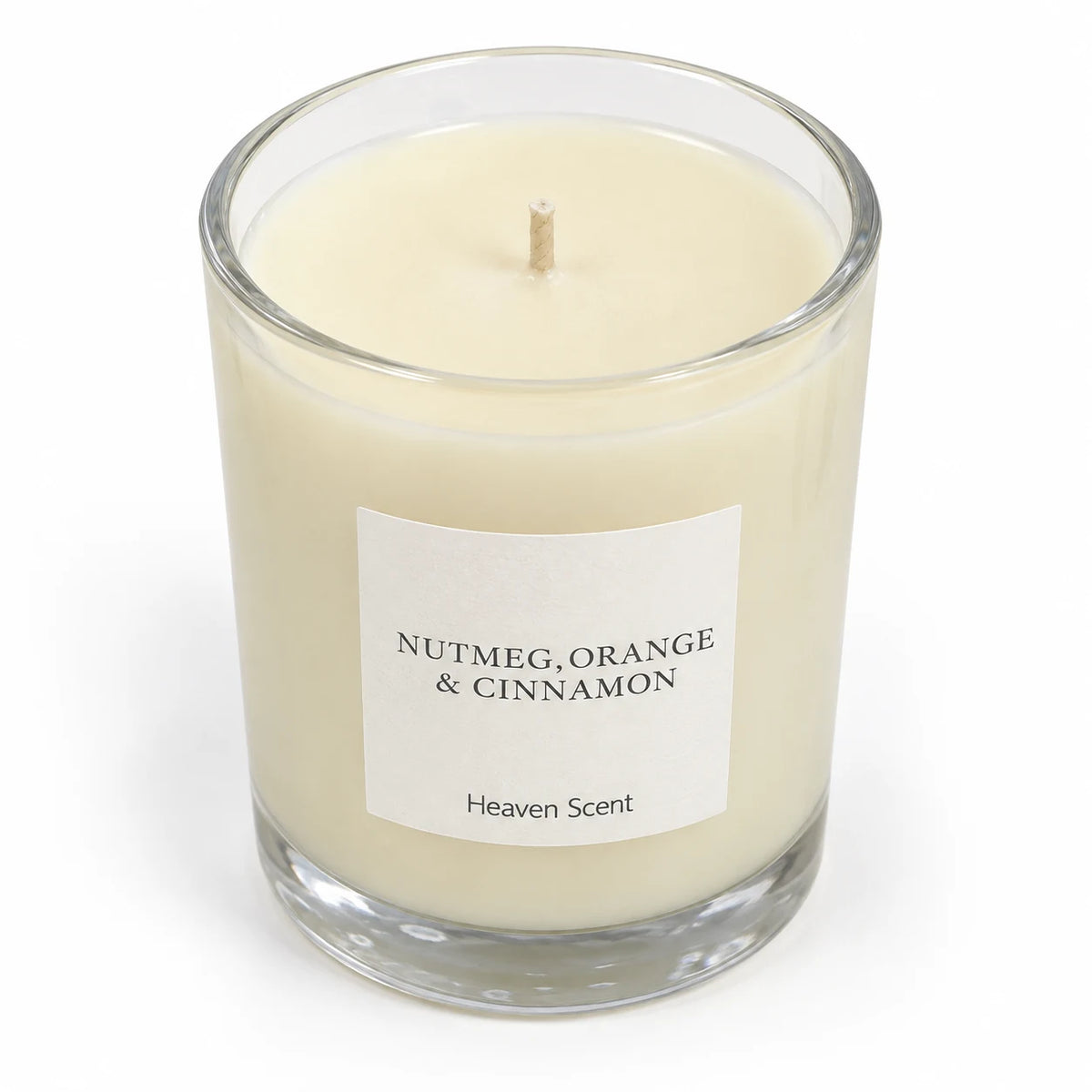 Heaven Scent Nutmeg, Orange + Cinnamon Medium Candle, close-up of cream wax and the unlit wick