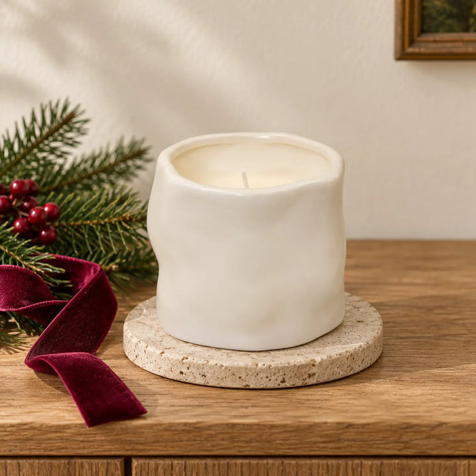 Off-white Satchville sculpted candle, elegant home decor piece with intricate detailing, ideal for festive or cozy settings.