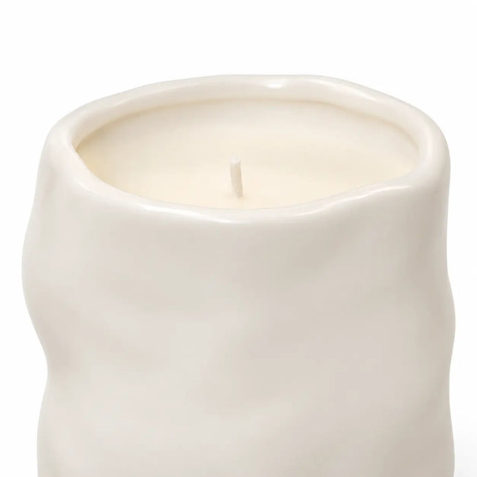 Off-white Satchville sculpted candle for home decor with intricate carved details, perfect for adding elegance to any space.