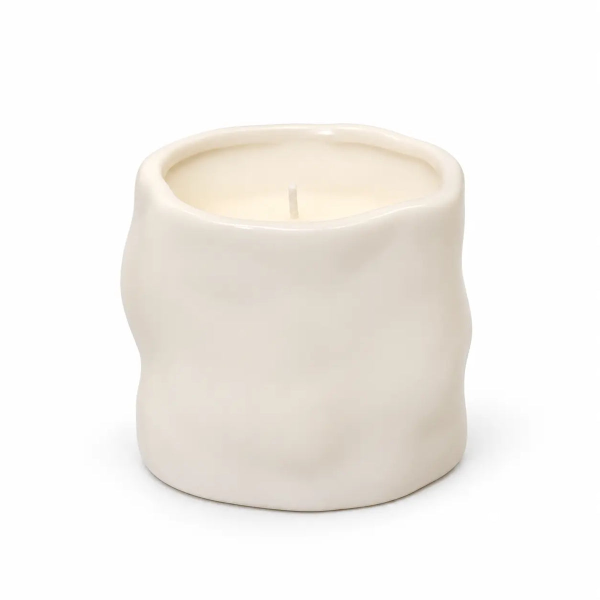Off-white Satchville sculpted candle for home decor, featuring intricate carved design and elegant shape.