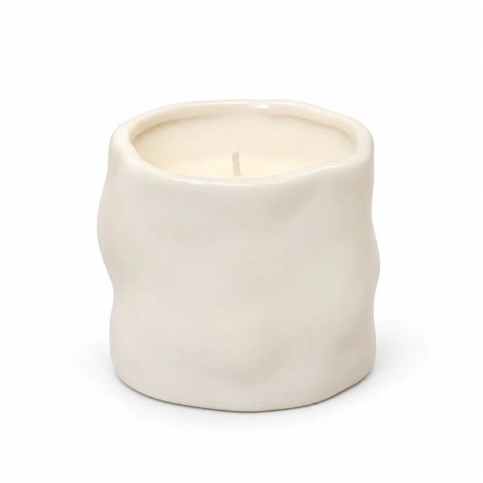 Off-white Satchville sculpted candle for home decor, featuring intricate carved design and elegant shape.