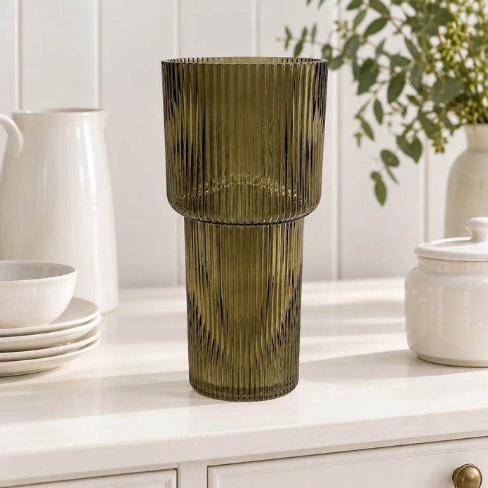 Satchville olive green tall glass ribbed vase displayed on a dresser