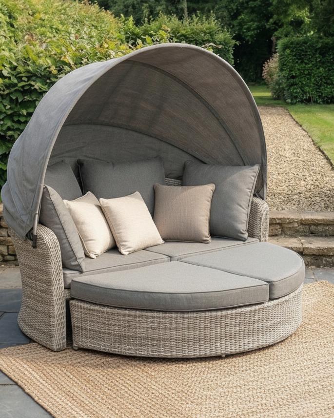 Natural rattan day bed garden furniture set by Pacific Lifestyle Ltd, featuring a comfortable outdoor seating arrangement in a garden setting.