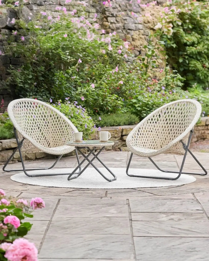 Cream rattan Snug garden furniture chair and table set by Pacific Lifestyle Ltd, featuring natural woven design for outdoor relaxation.