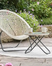Cream rattan garden furniture set with chair and table from Pacific Lifestyle Ltd, featuring natural woven design for outdoor relaxation.