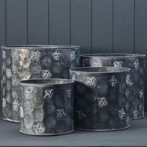 Set of four vintage bee-themed metal planter pots by Satchville, cylindrical baskets perfect for indoor or outdoor plants.