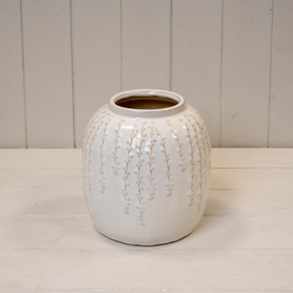 Rounded cream glazed ceramic vase with raised trailing leaf detail and an open neck