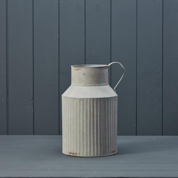 Ribbed metal vase by Satchville featuring a cylindrical shape with vertical ridges, ideal for modern home decor.