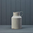 Ribbed metal vase by Satchville featuring a cylindrical shape with vertical ridges, ideal for modern home decor.