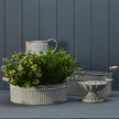Ribbed metal vase by Satchville, featuring a sleek cylindrical design with textured ribbing, ideal for modern floral arrangements.