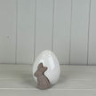 White ceramic egg with a bunny rabbit design, perfect for spring decorations by Satchville