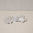 Original natural ivory ceramic bow tealight holder with sculpted loops, tails and empty central cup