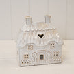 Natural ceramic thatch roof house for tealight, Satchville home decor piece with detailed thatched roof and cozy design.